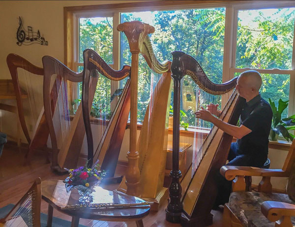 Eduard trying out our harps